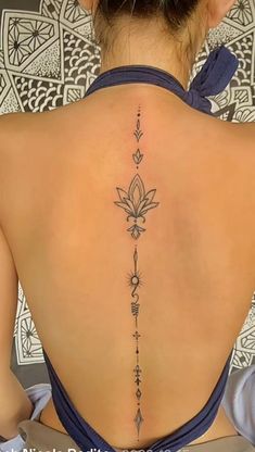 the back of a woman's upper back tattoo