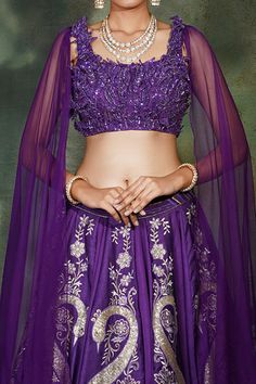 Purple lehenga with kasab and resham thread work, highlighted with stones. Comes with embroidered blouse including attached cape sleeves.
Component: 2
Pattern: Embroidery
Type Of Work: Kasab and Resham Thread work, Sequins, 3D Leaf Embroidery, Stones and Cut dana
Neckline: Square
Sleeve Type: Attached Cape sleeves
Fabric: Lehenga and Blouse: Raw Silk, Sleeves: Net
Color: Purple
Other Details: 
Peacock motifs
Note: The neckpiece worn by the model is not for sale
Occasion: Sangeet - Aza Fashions Elegant Purple Sets For Transitional Season, Elegant Transitional Purple Sets, Elegant Purple Transitional Season Sets, Floor-length Saree With Dori Work, Saree Set With Unstitched Blouse For Wedding, Unstitched Blouse Wedding Sets For Diwali, Wedding Sets With Unstitched Blouse For Diwali, Art Silk Unstitched Blouse Set For Wedding, Purple Blouse Piece With Dori Work For Reception