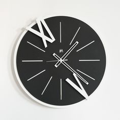 a black and white clock with roman numerals