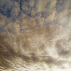 the sky is filled with clouds and there are no people on the beach or in the water