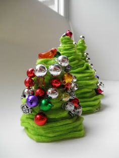 a small green christmas tree sitting on top of a white table