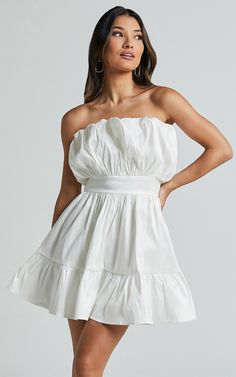 Ready to turn heads at your next party night? The Austine Mini Dress in Oyster is the ultimate showstopper. This strapless A-line dress features a playful and flirty design that accentuates your curves while keeping you comfortable all night long. Made from high-quality polyester, this white mini dress is both stylish and durable, making it perfect for every occasion. Whether you're hitting the dance floor or sipping cocktails with friends, this strapless dress will have you looking fabulous fro Strapless Flowy Mini Dress With Ruffles, Beach Strapless Mini Dress With Smocked Bodice, White Feminine Mini Strapless Dress, White A-line Mini Dress With Ruffle Hem, Beach A-line Mini Dress With Ruffle Hem, Party Night, White Mini Dress, Easy Wear, A Line Dress