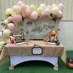 a table topped with balloons and stuffed animals