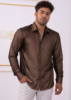 Limited edition- One of a kind A modern shirt with an unexpected edge. This brown metallic brocade shirt from Mondo is embellished with shine texture fabric detailed. Looking sharp Your style status can’t be messed with, and this shirt from Mondo makes that clear. A new and versatile wardrobe staple, great for under the blazer for dinner, party and special occasion night A tailored, modern cut and cotton fabric makes for a flattering shirt. Paired with a coordinating pant you'll have an elevated Designer Long Sleeve Shirt For Party, Designer Fitted Gold Top, Luxury Brown Long Sleeve Tops, Gold Fitted Luxury Top, Luxury Gold Long Sleeve Top, Luxury Fitted Gold Top, Luxury Long Sleeve Gold Top, Formal Festive Long Sleeve Tops, Designer Gold Top For Formal Occasions