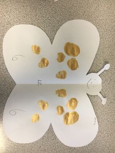 a paper butterfly with gold foil on it