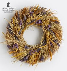 a dried wreath with purple and yellow flowers