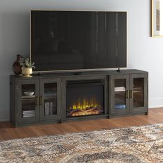 an entertainment center with a fireplace in the middle and a large television on it's side