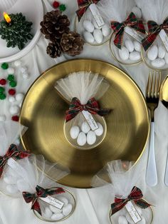 the table is set for christmas dinner with place settings, silverware and napkins