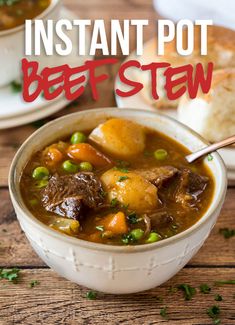 instant pot beef stew in a white bowl with a spoon and bread on the side