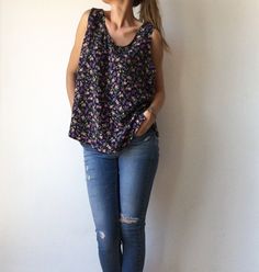 ⚡️Free shipping when you spend 100€⚡️ ⚡️Beautiful vintage sleeveless blouse, top with floral print, navy blue color with violet, dark pink and green flowers and leafs. ⚡️In excellent vintage condition. ⚡️ Fits best- S-M-L. ⚡️Reference model size M, height - 178 cm, weight - 60 kg. ⚡️Measurements: - Armpit to armpit, flat taken: 21,6 inch // 55 cm. - Length from armpit to bottom: 15 inch // 38 cm. - Length: 25,6 inch // 65 cm. ⚡️All items come from a smoke free home. ⚡️Please write me your phone Casual Purple Tank Top With Floral Print, Printed Sleeveless Cotton Blouse, Printed Cotton Sleeveless Blouse, Chic Printed Sleeveless Blouse, Cotton Floral Print Tank Top, Casual Tank Blouse With Floral Print, Chic Sleeveless Blouse With Floral Print, Sleeveless Patterned Blouse For Spring, Casual Floral Print Sleeveless Blouse