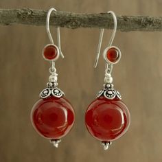 Believed to mirror the sun's energy carnelian the birthstone of July glows with fiery beauty in earrings by Narayani. Sterling silver settings reflect Indian elegance in earrings that are crafted by hand in India. .925 Sterling silver Elegant Carnelian Dangle Earrings, Elegant Carnelian Earrings, Elegant Carnelian Earrings For Gift, Elegant Carnelian Earrings Gift, Spiritual Agate Gemstone Earrings, Red Agate Earrings For Gift, Red Agate Earrings As Gift, Carnelian Gemstone Dangle Earrings, Amber Carnelian Gemstone Earrings