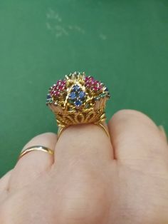 "Beautiful, unique, outrageous vintage18K multi stone ring. There is no karat stamp, but has been tested as 18K. It weighs 14.8 grams, and is set with the following approximate weights of stones: .30 ctw genuine emeralds, .59 ctw genuine sapphires, and .70 ctw genuine rubies. It is between a size 7 1/2 and 8. It has \"bumps\" inside the ring which leave a small gap, when measuring it in a mandrel. There is one flaw in the ring. There is a missing emerald, due to a broken prong. I have this area Yellow Gold Multi-stone Ruby Ring, Multicolor Sapphire Ring With Prong Setting For Formal Occasions, Unique Multi-stone Ruby Ring In Yellow Gold, Multi-stone Ruby Ring In Yellow Gold, Formal Multicolor Sapphire Ring With Prong Setting, Vintage Jeweled Round Rings, Heirloom Multicolor Rings For Formal Occasions, Heirloom Multicolor Rings For Formal Events, Vintage Multi-stone Sapphire Ring Gift