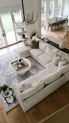 a living room filled with lots of white furniture