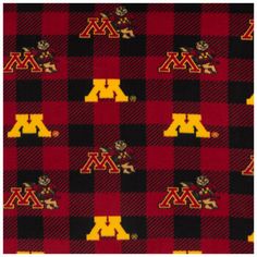 a red and black plaid fabric with the letter m on it