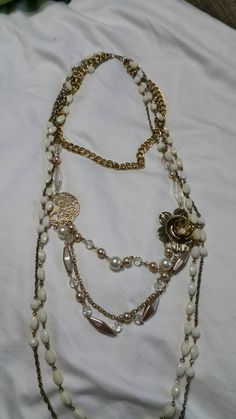 Hippie Chic, One of A Kind, 5 Strand, Gold Toned Double Curb Chain and Cable  Chains, 36 inch Necklace with Charms and Faux Pearls  This is a nice find and very decorative.  In great shape and priced to sell. The top chain is 15 inches long and was recycled from a Napier Necklace.  The measurement for the rest of the necklace was taken from the bottom chain. Check out our shop for monthly specials. We have a variety of items for every taste. Combine several of our items together to save on shipping. If you have any questions please do not hesitate to ask. I will ship outside of the US, just request a quote. Happy Shopping. I will work around the priority mail price. Just send me your zip code and I will get a quote. As shop owners we will do our best to describe any issues or problems with Necklace With Charms, Hippie Chic, Curb Chain, Cable Chain, Long Necklace, Priority Mail, Faux Pearl, Charm Necklace, Jewelry Necklace Pendant