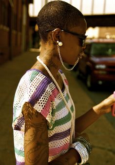 a woman with tattoos is looking at her cell phone