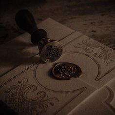 a waxed seal sitting on top of a piece of paper next to a stamp