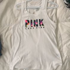 Pink Xs Nwot Never Worn White Tank Top Open Back With Bright Lettering On Front Font Open Back... Perfect For Summer Casual White Racerback Top, White Racerback Trendy Tops, White Trendy Racerback Tops, Trendy White Racerback Top, Virtual Closet, Muscle Tees, White Tank Top, White Tank, Victoria's Secret Pink