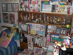 a room filled with lots of different types of toys and books on shelves next to a bed