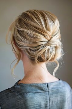 a woman with blonde hair in a low bun