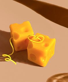 two pieces of yellow soap sitting on top of a table next to a pair of scissors