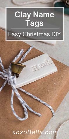 a wrapped present with the words clay name tags easy christmas diy on it and tied up in twine