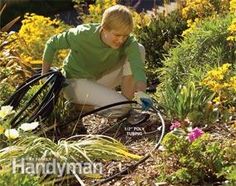 a young man is watering the plants in his garden