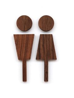 two wooden utensils are shown on a white background, one is shaped like a man and the other is shaped like a woman