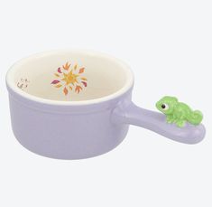 a purple bowl with a green frog in it