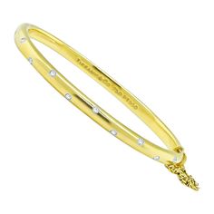 This is a gorgeous 18k yellow gold and platinum etoile bangle by Tiffany & Co. The bangle is set with sparkling round cut diamond accents. The bangle measures 4.75mm in width and weighs 30.3 grams. The bangle is signed TIFFANY&Co 750 PT950. Tiffany And Co Diamond, Tiffany And Co, Diamond Gold, Gold Platinum, Round Cut Diamond, Tiffany & Co., Round Cut, Gold Diamond, Bangle Bracelets