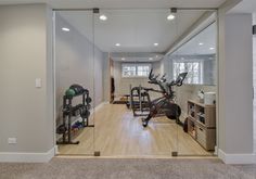 a home gym with mirrors and exercise equipment