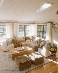 a living room filled with furniture and lots of windows