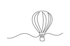 a hot air balloon flying in the sky with a ribbon around it's neck