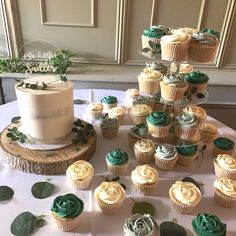 White and green themed wedding cakes with ecalyptus Gold Green Wedding Cake, Green And White Bday Theme, Olive Green Cake Ideas, Olive Green Wedding Cake Ideas, White And Green Wedding Cupcakes, Forest Green Wedding Cupcakes, Sage Green Wedding Cake And Cupcakes, Eucalyptus Wedding Cupcakes, Sage And White Cupcakes