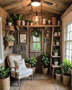 a room filled with lots of potted plants next to a wall mounted book shelf