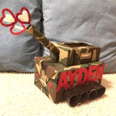 an army themed box with a red bow on it and the word andy written in large letters