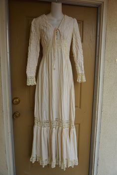 Size 13 Gunne Sax prairie dress fits smaller - please see measurements.  Zips in the back with adjustable tie at the back of the waist. Condition - has one small spot mid skirt to the side - see last photo.Measurements taken across front lying flat18" across front armpit to armpit14" across front of waist (ties tighter)59" length Bohemian Long Sleeve Maxi Dress With Lace Trim, Elegant Fitted Long Sleeve Peasant Dress, Long Sleeve Lace Maxi Dress With Lace Trim, Bohemian Cream Maxi Dress For Fall, Lace Trim Maxi Dress For Fall, Maxi Dress With Lace Trim For Fall, Fall Maxi Dress With Lace Trim, Fitted Cream Victorian Dress With Long Sleeves, Bohemian Fitted Dress With Lace-up Back