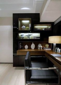 a modern home office with black leather chairs