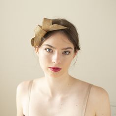 The gold fascinator in minimalist loops shape is perfect for wedding guests, bridesmaids, or even the mother of the bride or groom. It adds a formal, sophisticated touch and pairs beautifully with dresses in solid colors or subtle patterns. The metallic sheen of gold can complement both light and dark outfits, making it a versatile choice for wedding attire. The fascinator is made of premium millinery sinamay, it is a lightweight material known for its durability, making it the perfect choice fo Chic Structured Crown Headpiece For Party, Chic Headpieces For Events, Chic Fascinator Headband For Events, Chic Headband Fascinator For Events, Gold Mini Hat For Evening In Spring, Gold Mini Hat For Spring Evening, Gold Mini Hat For Spring Evenings, Chic Adjustable Fascinator With Pinched Crown, Elegant Headpiece With Pinched Crown For Gift