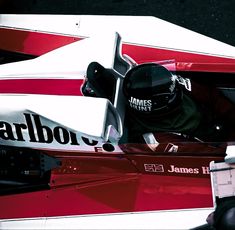 a man sitting in a racing car on top of a track