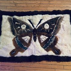 a close up of a rug with a butterfly on it