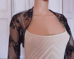 This is a beautiful hand made dark blue lace shrug ideal for weddings or special occasions. The shrug has a navy blue satin edging. It can also be worn with casual wear. It can be made in any size from 8 to 24 (UK sizes). It is made in the UK. It is normally sent out to you within 5 days, but I am very happy to make your order a priority if you need it urgently. Just let me know the date needed by. Postage is free in the UK! International postage is £9. I am happy to exchange items or refund you Evening Shrug With Lace Trim, Fitted Lace Shrug With Lace Trim, Elegant Long Sleeve Stretch Shrug, Party Lace Shrug With Lace Sleeves, Spring Party Lace Shrug, Fitted Evening Shrug With Lace Sleeves, Evening Fitted Shrug With Lace Sleeves, Long Sleeve Lace Shrug For Party, Fitted 3/4 Sleeve Party Shrug