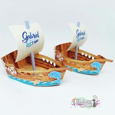 two small wooden boats with flags on them