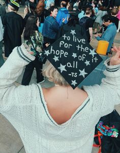 a woman wearing a graduation cap that says to live for the hope of it all