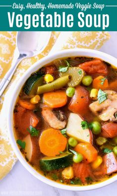 a white bowl filled with vegetable soup on top of a table