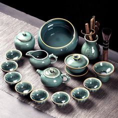 a collection of teapots and cups on a table