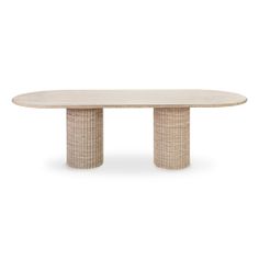 an oval dining table with two columns on each end and a circular top, made from wicker