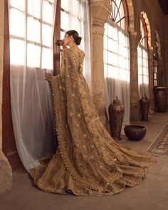 Pakistani Bridal Dress in Golden Gharara Kameez and Dupatta Style is a traditional masterpiece Adorned with Dabka, Naqshi, Resham, and Shimmering sequins. Golden Gharara, Gold Pakistani Bridal Dress, Kameez Style, Bridal Gharara, Gold Dupatta, Net Shirt, Pakistan Wedding, Pakistani Bridal Dress, Dupatta Style