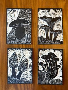 four black and white paintings on wood with mushrooms in the middle, one is an eggplant