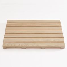 a wooden board sitting on top of a white table